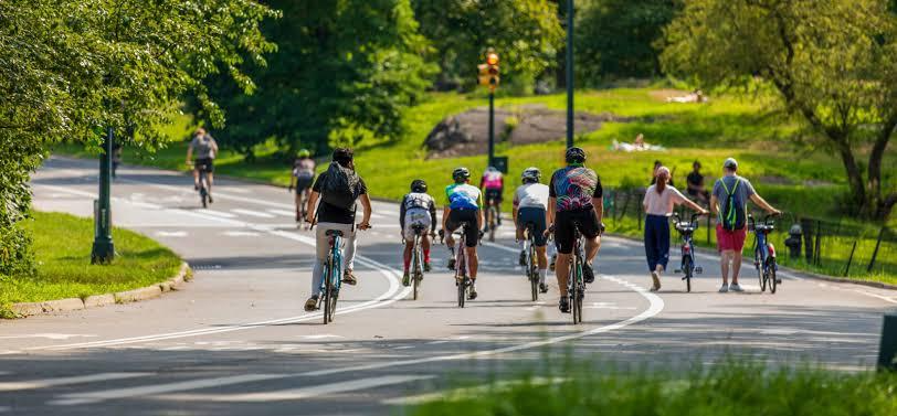 Cyclists riding on a road of Central Park NY