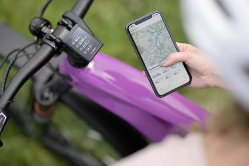 A Mobile Phone in Hand Using Google Map While Sitting on Ebike