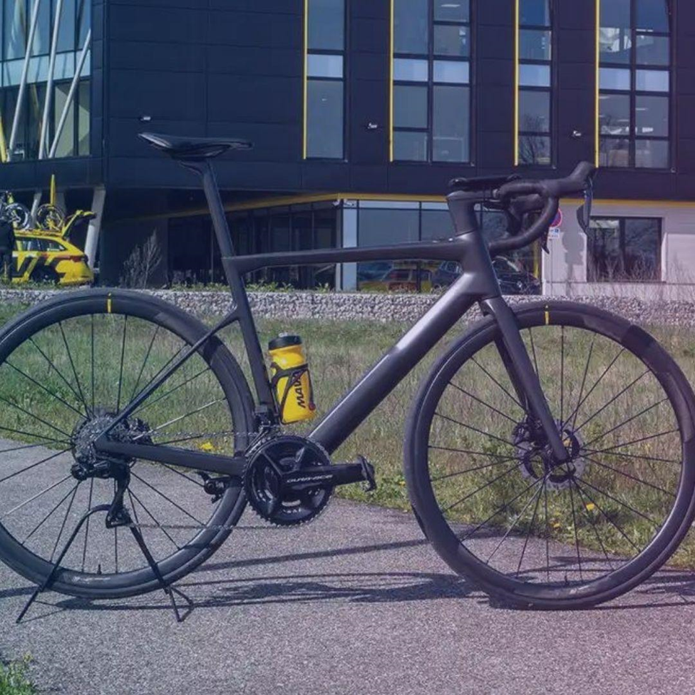 A Ebike Stands on Road in Front of a Building