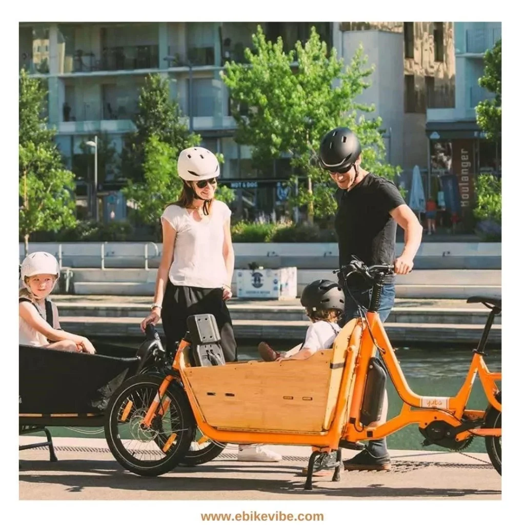 A group of people standing around a wooden electirc bike.