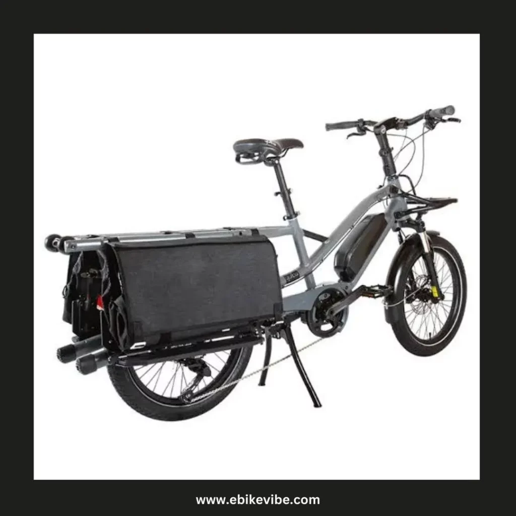 A black electric cargo bike with a basket on the back of it