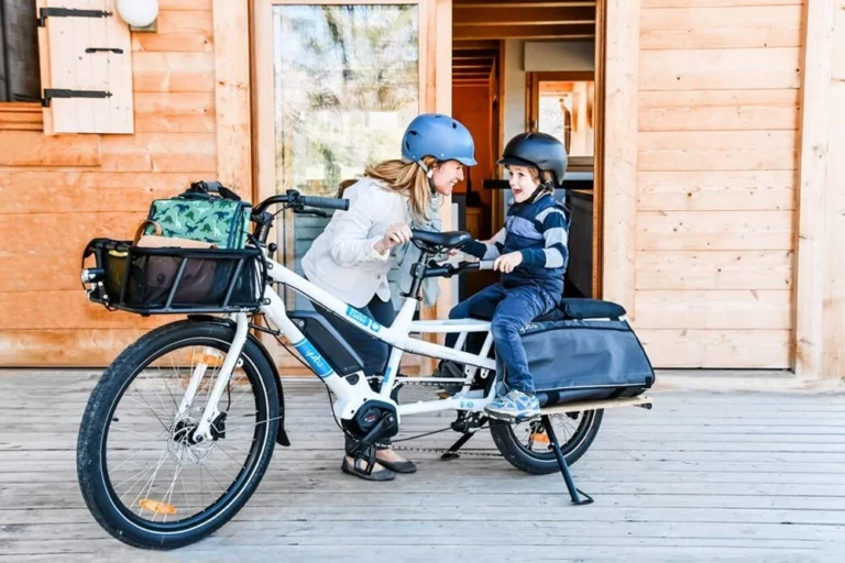 A woman and a child on a electric bike.