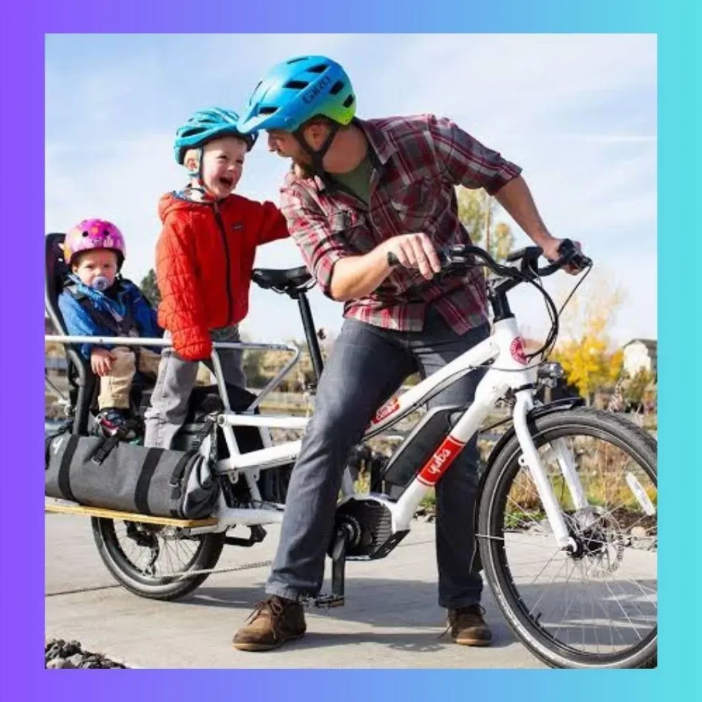A man riding a ebike with two children on the back.