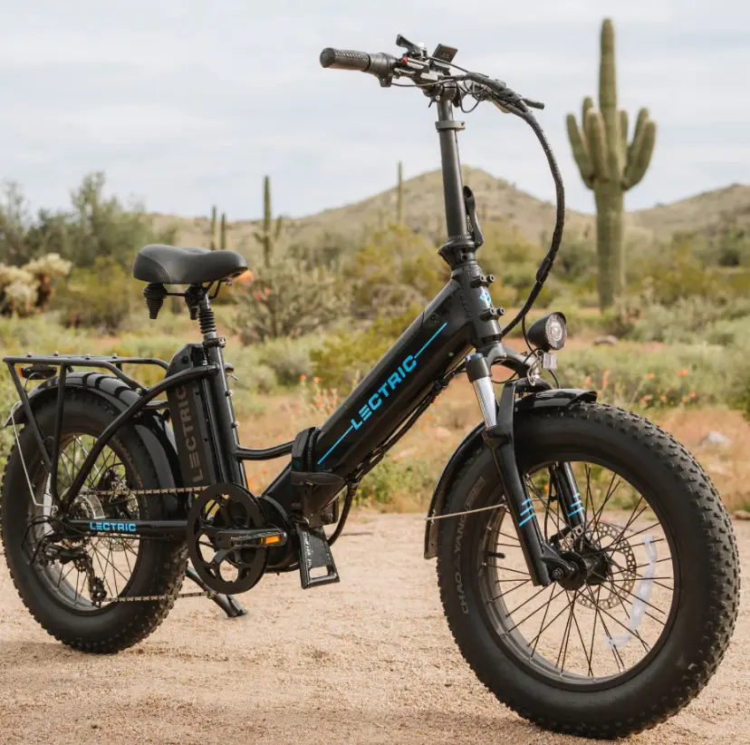 A black electric bike parked in the desert.