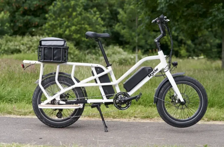 A white electric Cargo bike with a basket on the back.