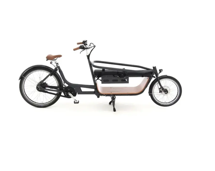 A black electric Cargo bike with a basket on it.