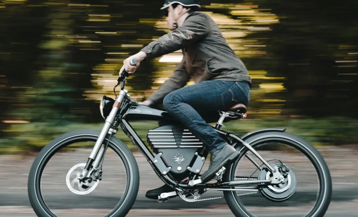 Man riding a stylish electric bike on a city road, illustrating “Which Electric Bike is Good for Commuting?” with a comfortable, urban-friendly ebike design.